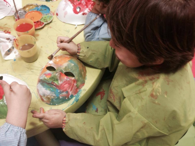  child painting a mask 